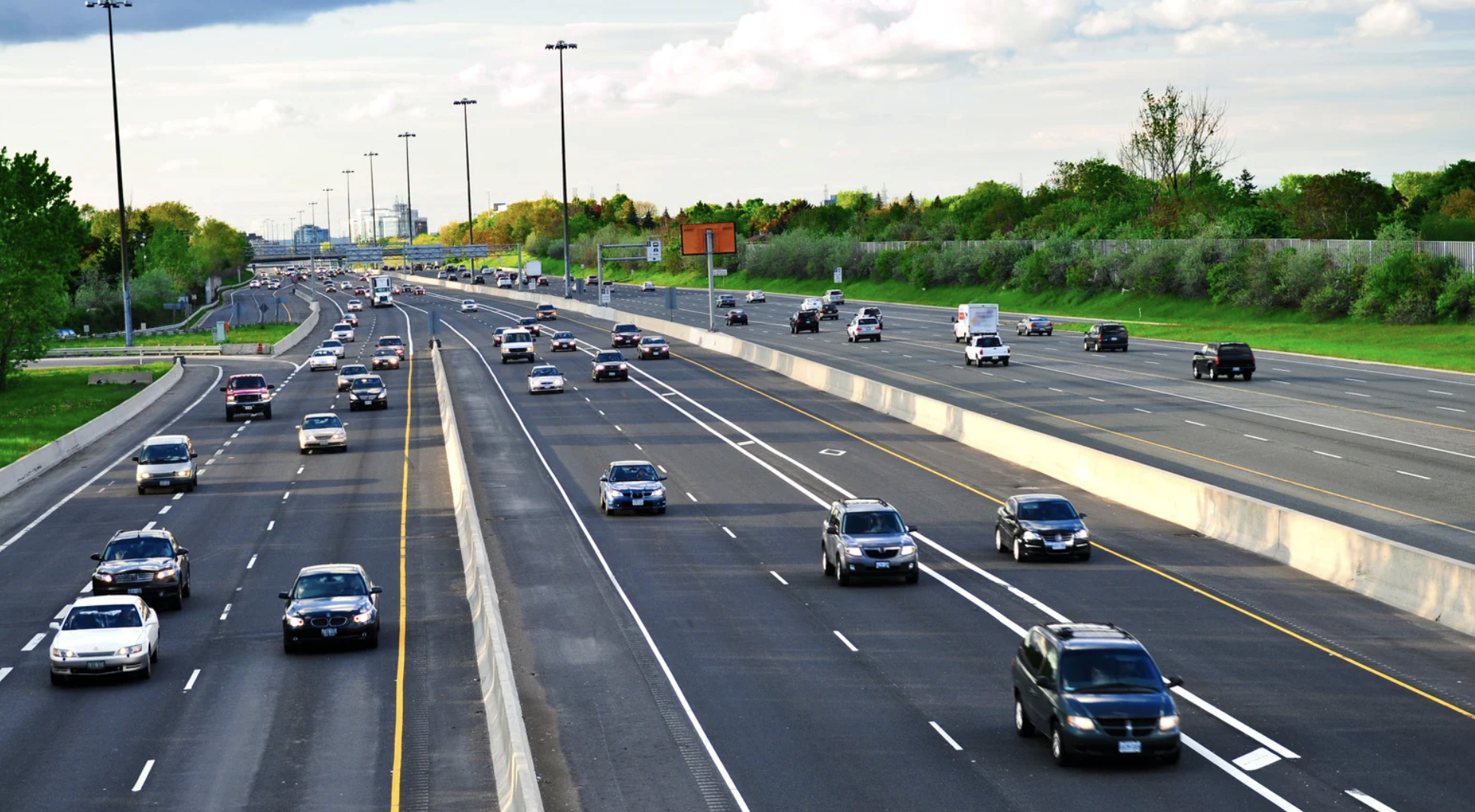 Highway scene in Texas with multiple vehicles traveling in both directions, emphasizing safe driving and lane changes.
