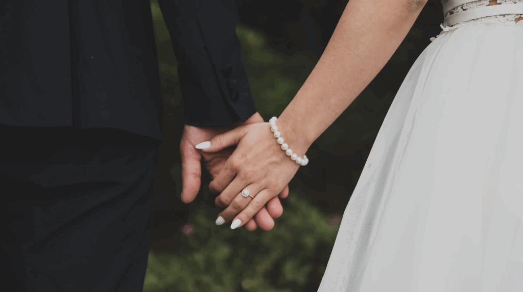 Couple holding hands, symbolizing love and commitment, relevant to adoption discussions in Texas.