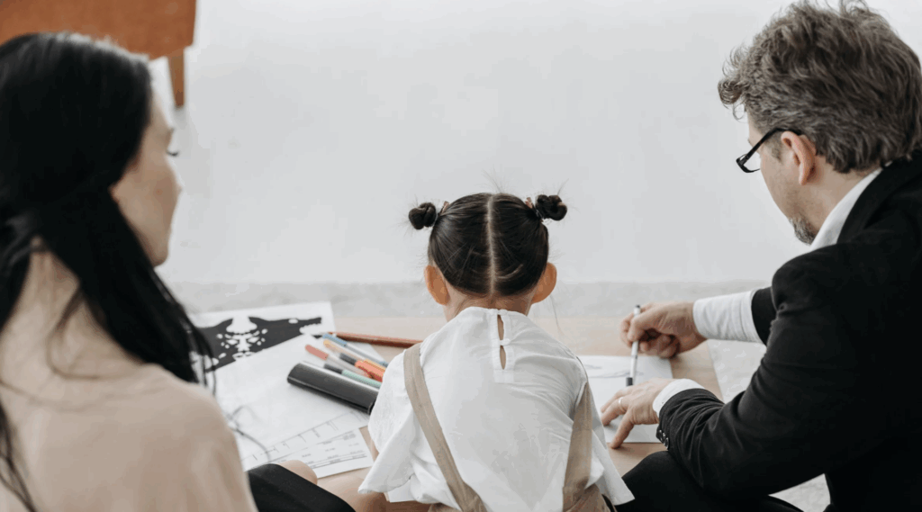 Screenshot 2025-09-10 at 7.13.20 PM Family engaged in private adoption process, child drawing with adoptive parents, emphasizing family growth and connection.