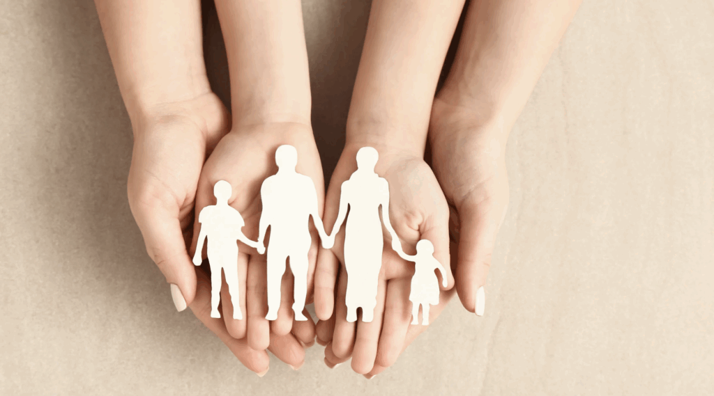 Screenshot 2025-09-10 at 7.20.42 PM Hands holding cut-out figures representing a family, symbolizing the adoption process and family creation in Texas.
