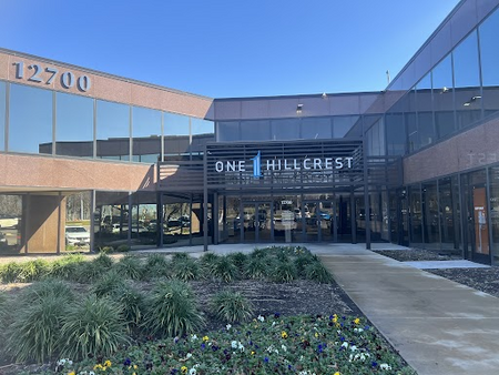 Dallas office building of the Law Office of Bryan Fagan located at 12700 Hillcrest Rd, featuring modern architecture and landscaping.