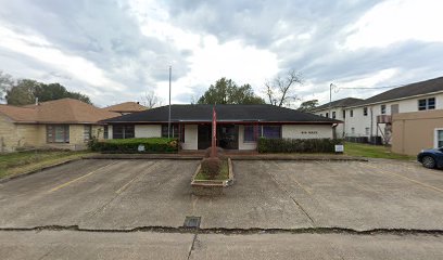 Humble office location of the Law Office of Bryan Fagan, featuring a single-story building with a parking lot, surrounded by residential structures, indicating a welcoming environment for adoption services.